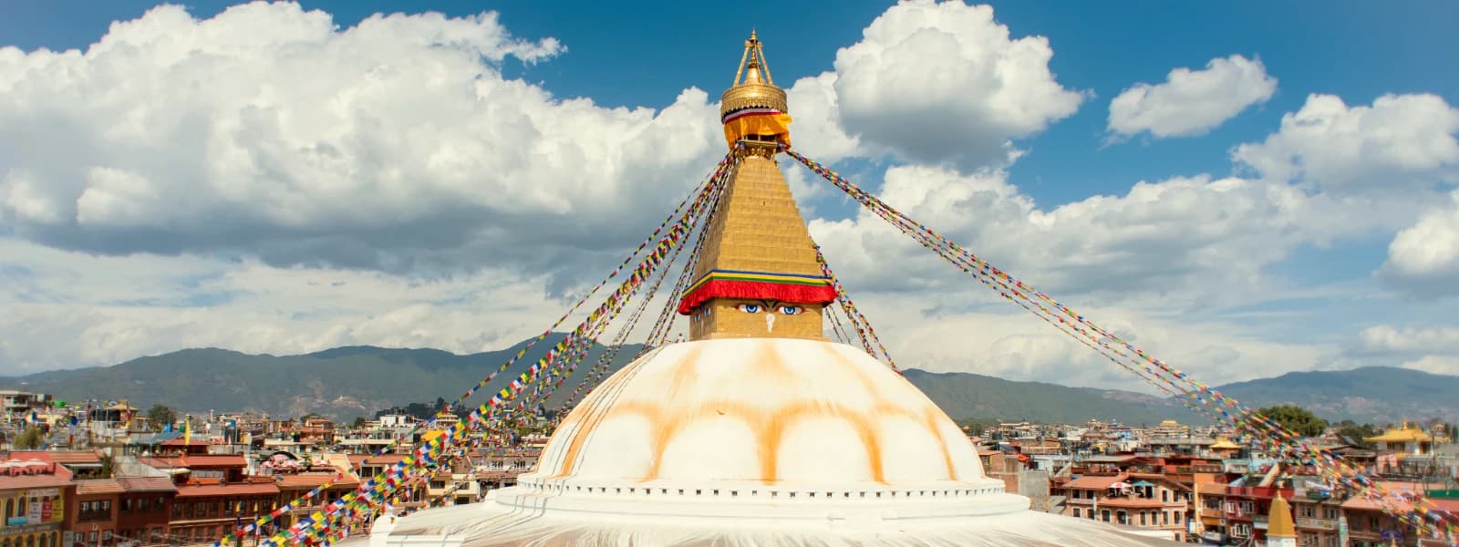 Boudhanath Stupa in Kathmandu, Nepal, adorned with prayer flags, symbolizing peace and spirituality.
