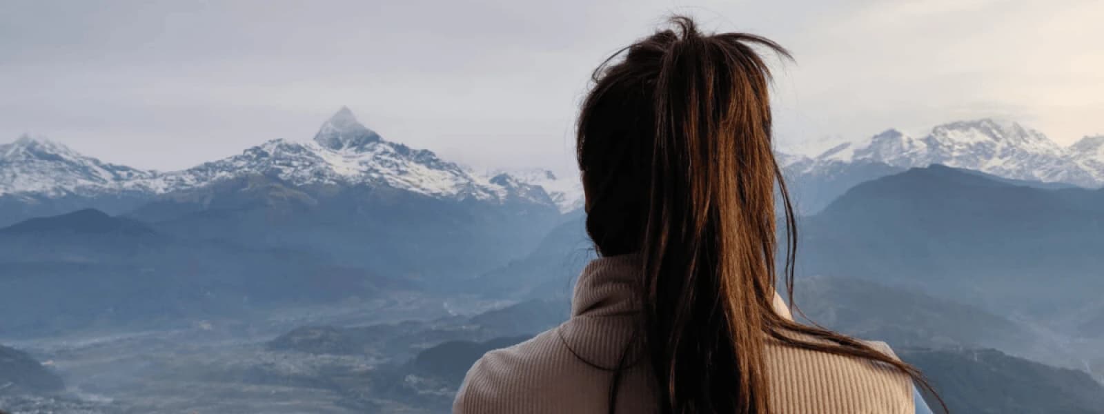 girl looking at mountain from pokhara sarangkot