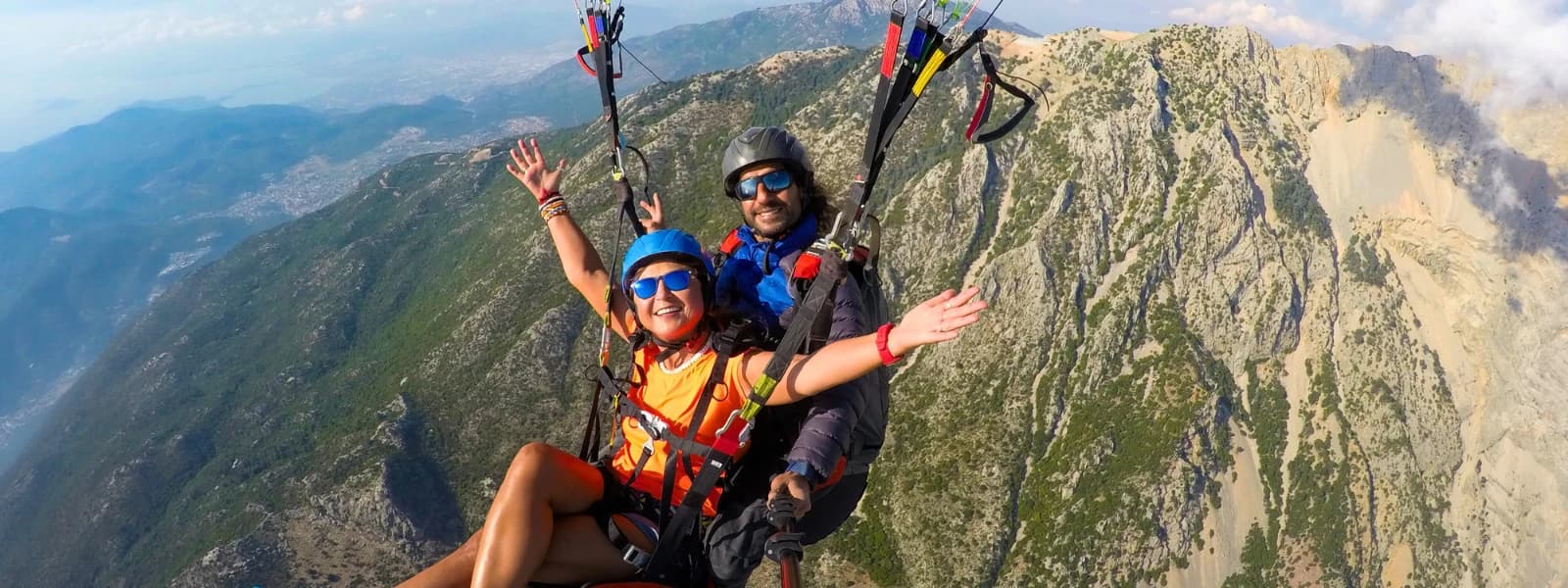 Traveler enjoying tandem paragliding adventure with instructor in Pokhara.