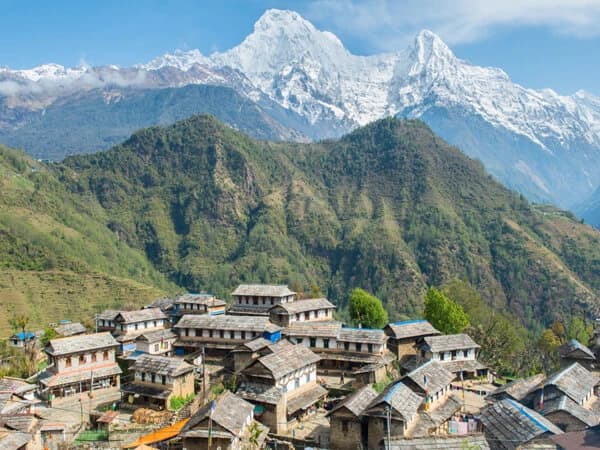 Alt Text: The charming Ghandruk village, encircled by the Annapurna mountain range, features traditional stone buildings and terraced fields.
