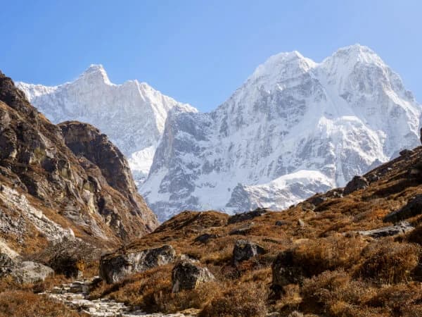 Trekkers enjoying panoramic views of the majestic Kanchenjunga mountain range during their trek
