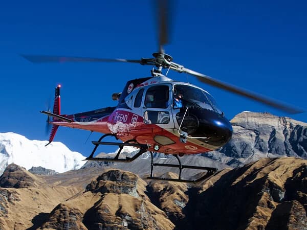 Helicopter flying over the Langtang Valley with snow-covered peaks